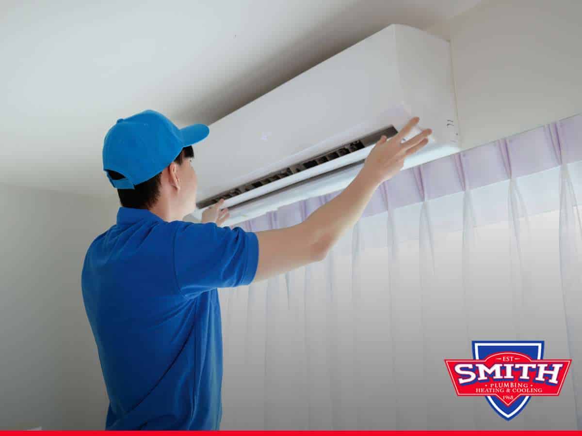 Technician inspecting an Air Conditioner